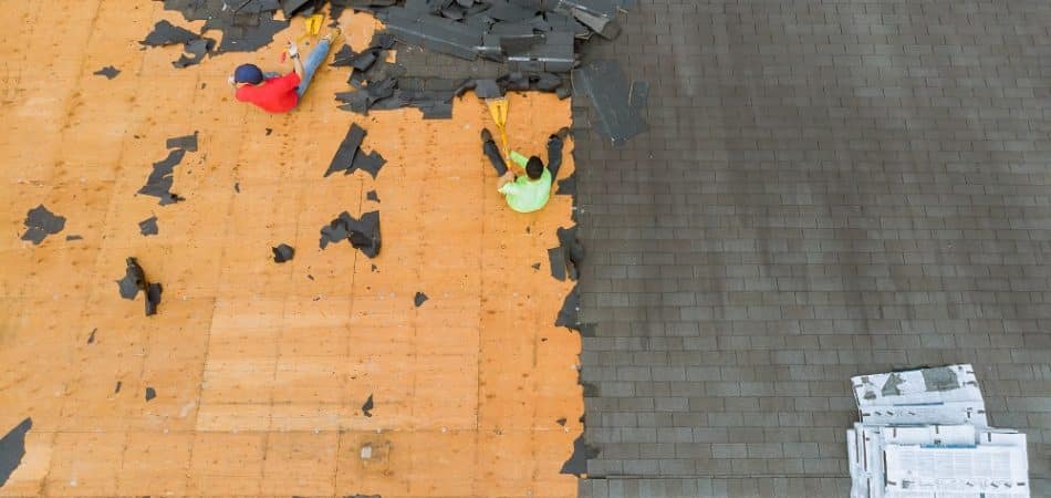 Removal of old roof replacement with new shingles of an apartment building