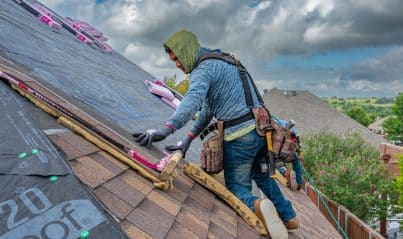 Roofing crew replacing an asphalt shingle roof on a New Orleans home in one day