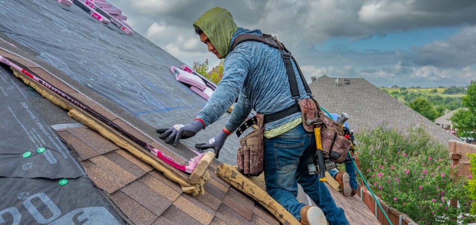 Roofing crew replacing an asphalt shingle roof on a New Orleans home in one day