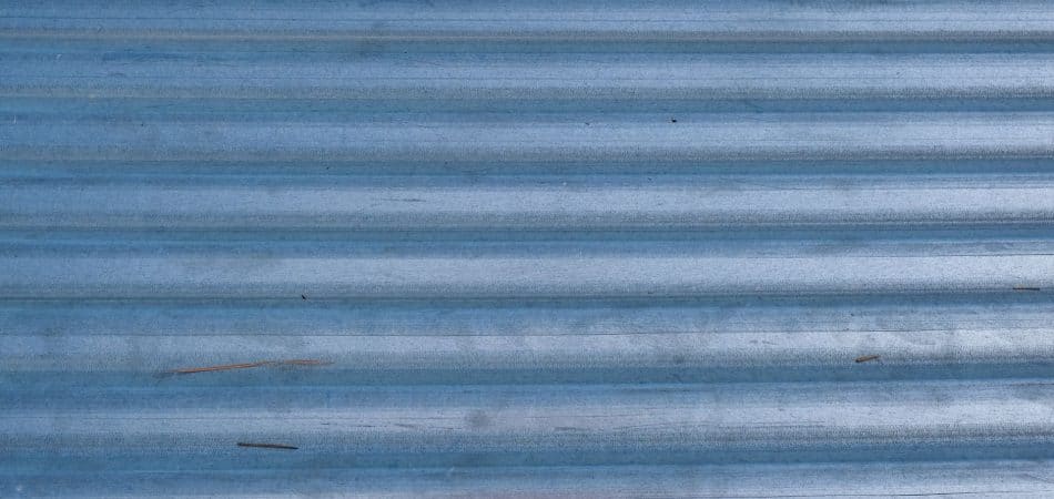 Standing seam metal roof panels compared to exposed fastener metal roofing on a Louisiana home