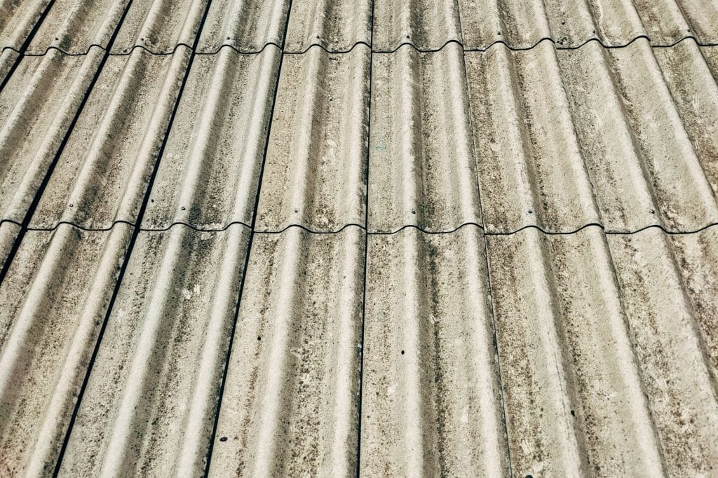 Close-up of synthetic roof underlayment texture compared to traditional felt paper.