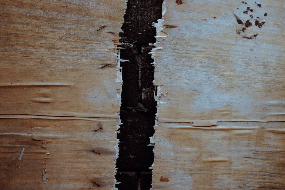 Close-up of sagging vinyl soffit panel with visible gaps