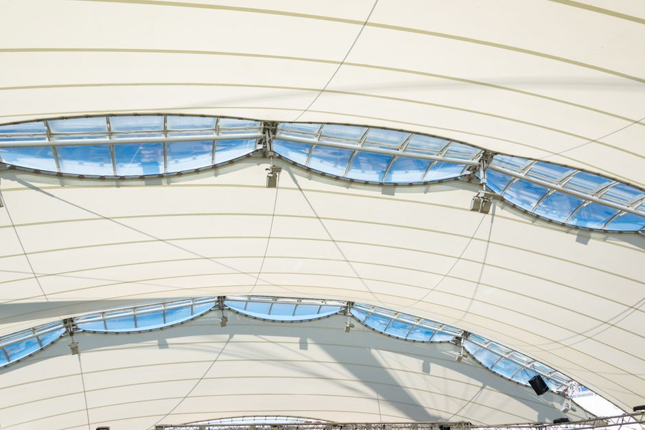 Technician using electronic leak detection equipment on a membrane roof